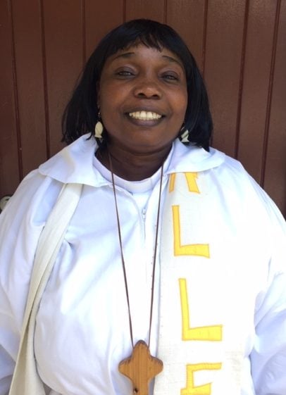 Woman priest in white robes