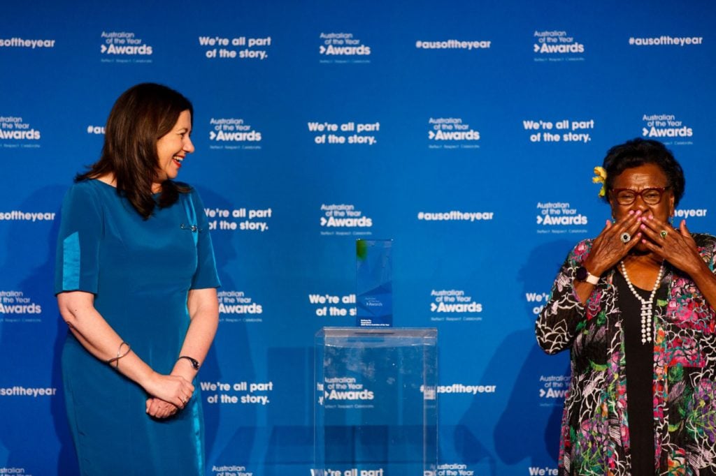 Torres Strait Islander elder on a stage with a politician 