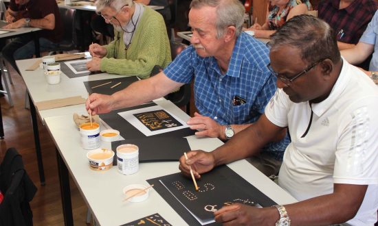 Western Region Clergy Muster: clergy participants engaged in an Aboriginal dot painting