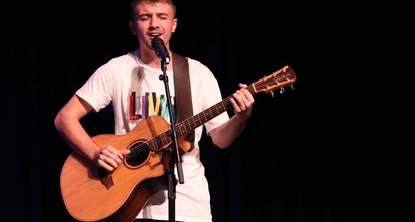 Jackson King playing the guitar