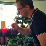 The Rev'd Andrew Schmidt test lighting the first Advent candle in the St Margaret’s, Nerang