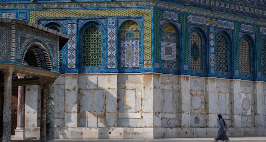 A woman approaches the Dome of the Rock at Al-Aqsa Mosque in Jerusalem