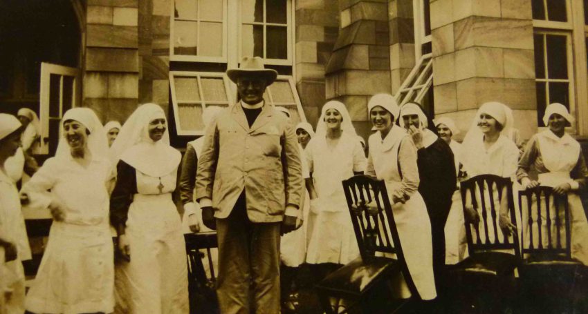 St Martin’s War Memorial Hospital nurses and a clergyperson in the 1930s
