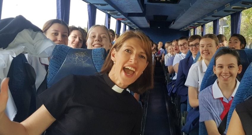 The Rev’d Canon Sarah Plowman with students on a bus to a valedictory Cathedral service in 2017