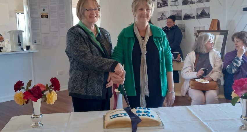 Merry Higgins and Carmel Jensen cutting the anniversary cake at St Alban's Cunnamulla celebration in May 2023