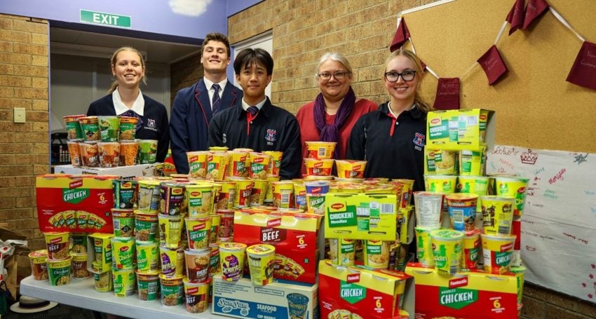 Becket Head of House and Student Leaders with the collected cups of noodles