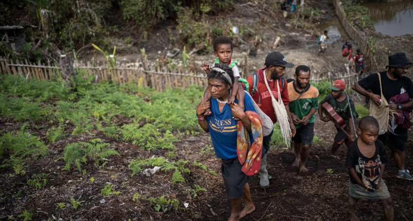 Early morning in a jungle camp where IDPs hide from Indonesian forces.