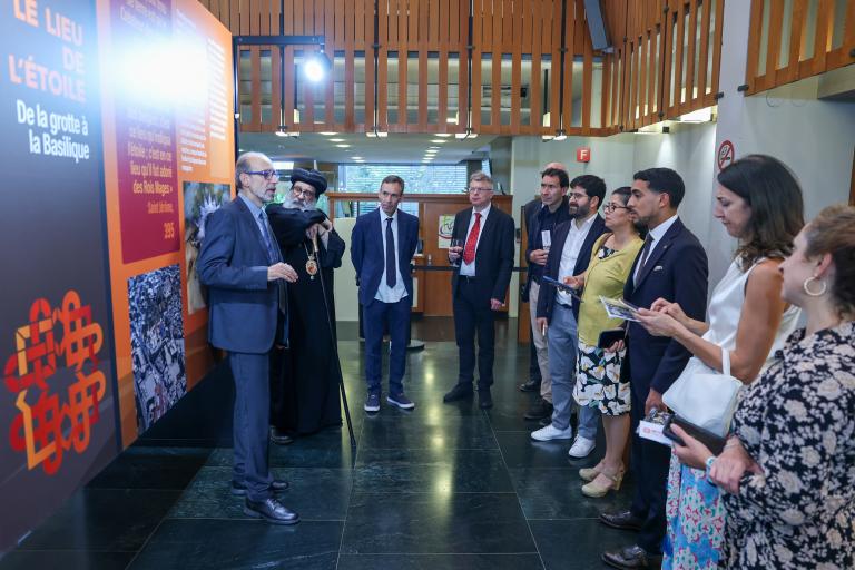 Taisir Hasbun, curator of the exhibition "Bethlehem Reborn" provides a guided tour to the visitors at the opening event of the exhibition at the Ecumenical centre, Geneva, Switzerland on 12 September 2023