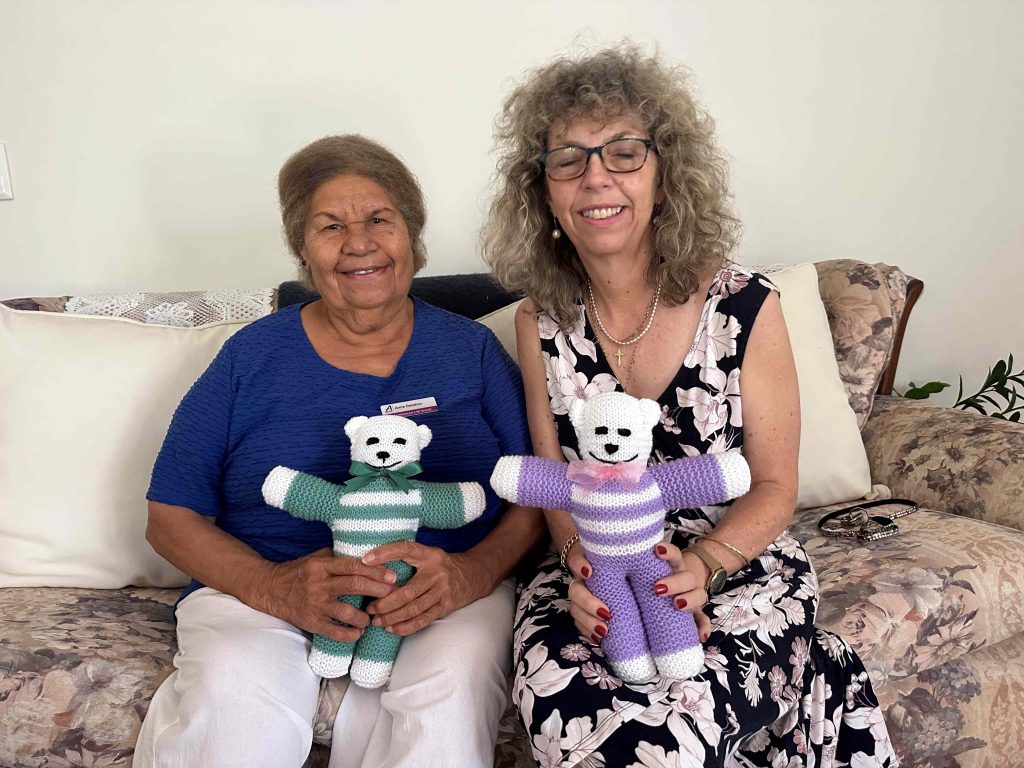Anne Daddow and Joanne Rose from the Bishops' office holding Anne's knitted teddy bears