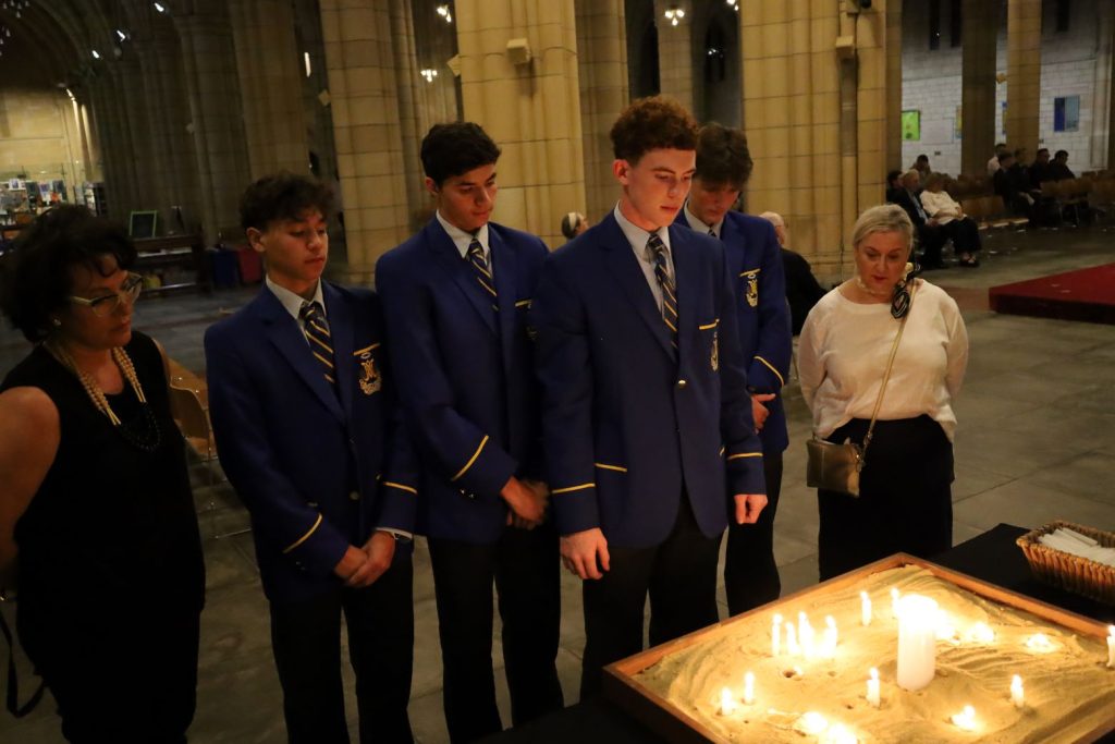 Students and teachers praying at the candle-lighting prayer space at the 25 October 2023 vigil for Palestine and Israel in St John's Cathedral