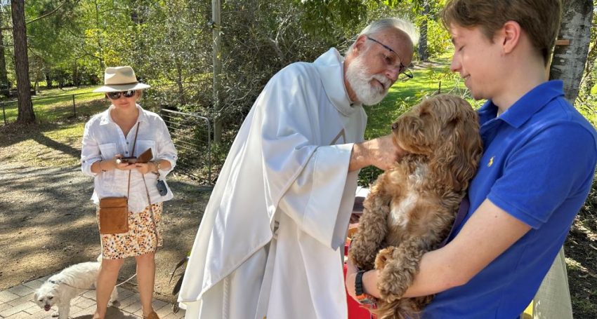 The Rev'd Robert Paget blessing a dog during the Season of Creation