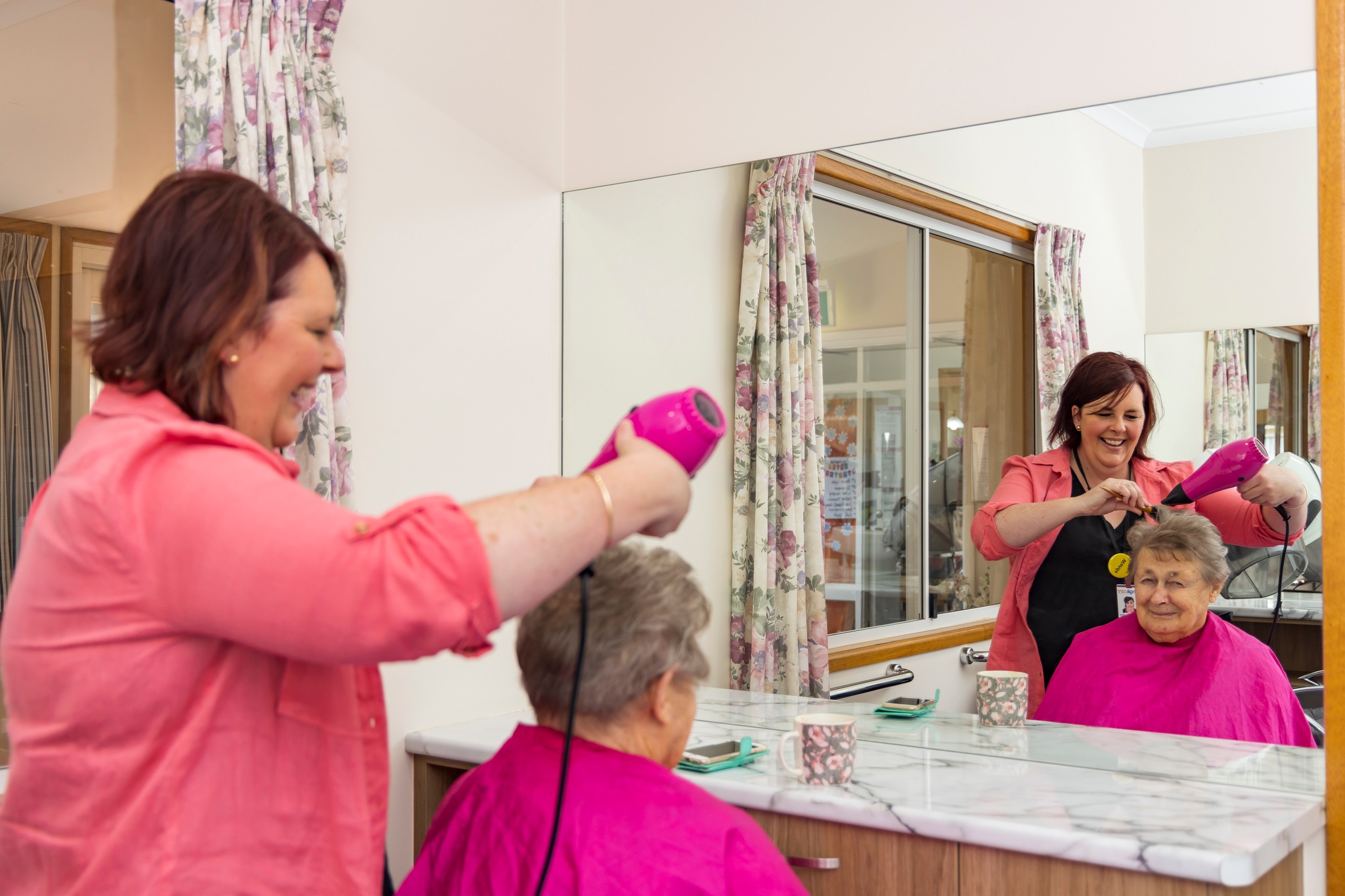 Anglicare Southern Queensland Facebook on 17 July 2023: "At Symes Thorpe Residential Aged Care, our residents have access to a unique range of features. Some of these features include; a on-site chapel and salon, as well as 24-hour nursing and care services. Pictured: a Symes Grove resident getting her hair done and looking fabulous!"