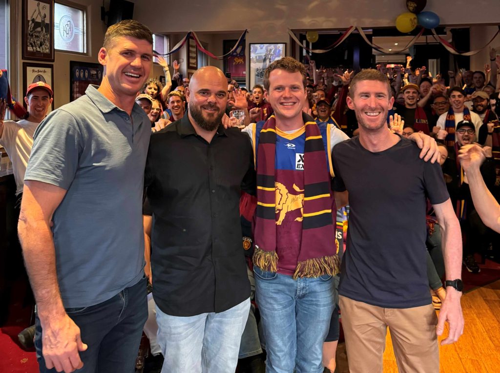 Dom Fay with his "Roar Deal" podcast cohost Mike Whiting as well as AFL heroes Jonathan Brown and Ash McGrath, taken at a live recording of the podcast in Grand Final week in Melbourne in 2023
