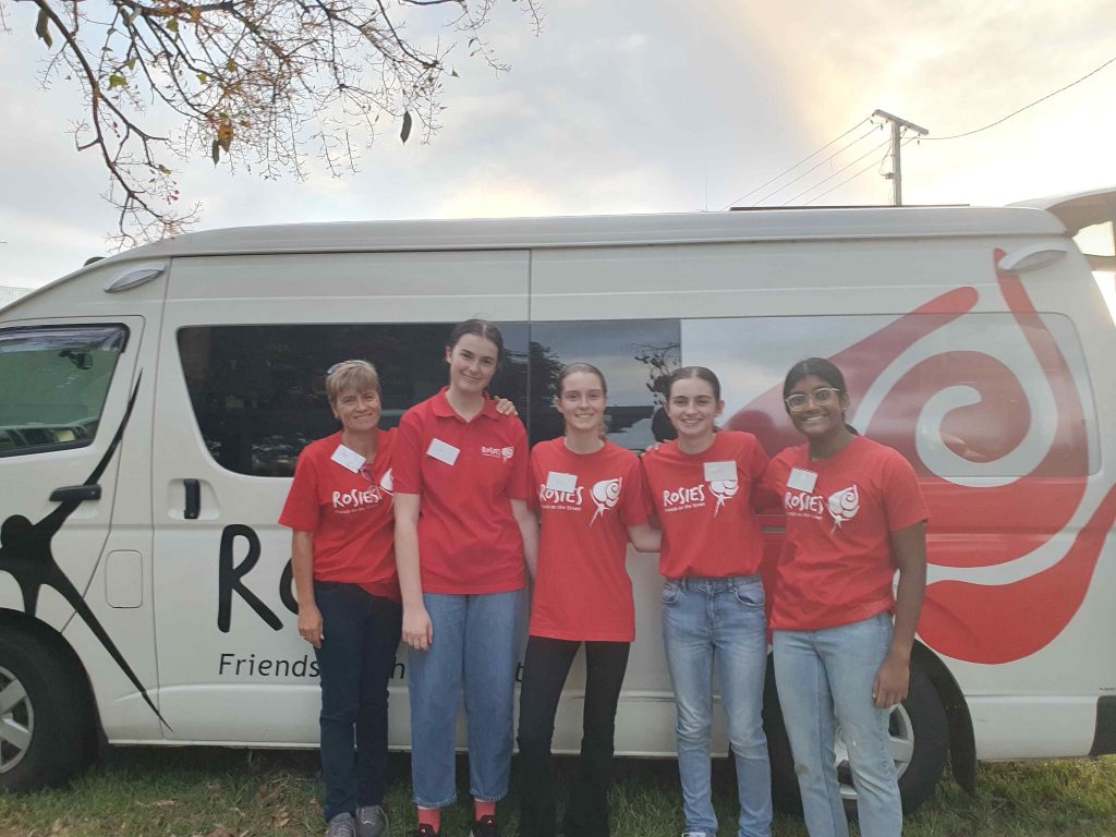 Five women standing in front of a Rosies outreach bus 