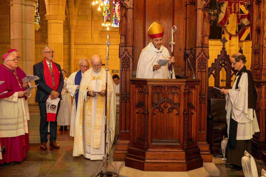 The new Archbishop, The Most Rev’d Jeremy Greaves, being installed in the cathedra, or “seat”, by Cathedral Dean, The Very Rev’d Dr Peter Catt with the support of ecumenical leaders