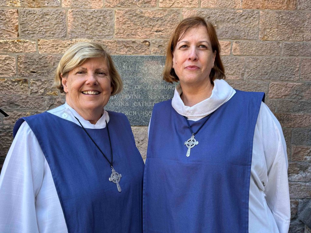 Two women priests outside St John's Cathedral 