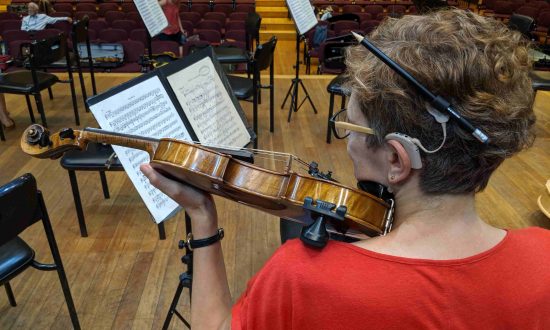 Woman with cochlear implant playing violin