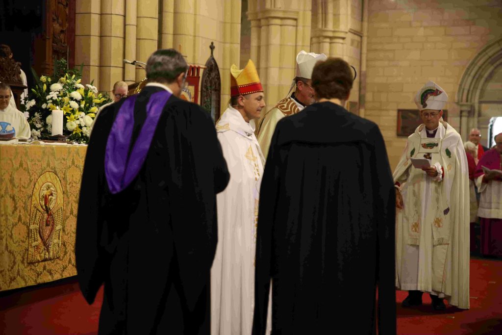 Archbishop-elect, Jeremy Greaves standing before senior clergy and lay leaders in the Cathedral sanctuary 