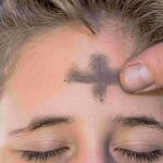 Ashes applied to teenager's forehead on Ash Wednesday