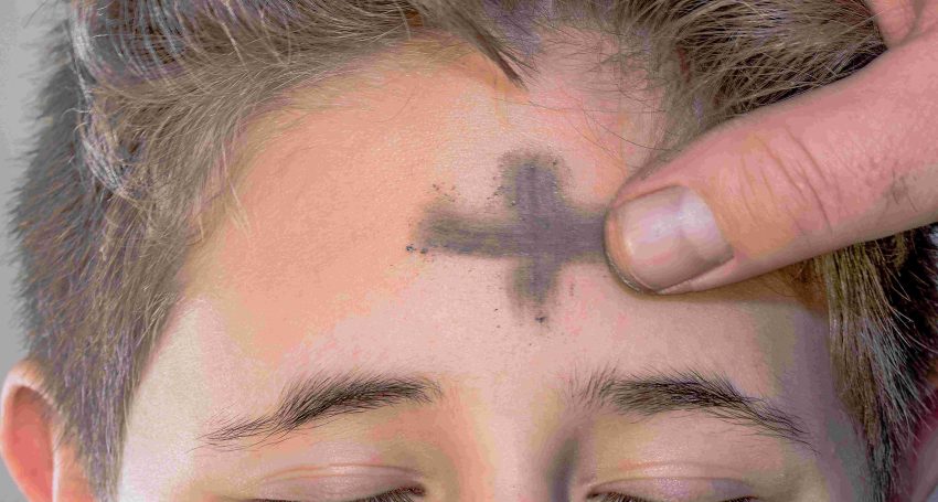 Ashes applied to teenager's forehead on Ash Wednesday