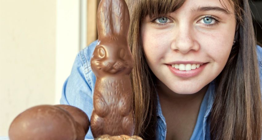Teenager with Easter eggs and chocolate Easter bunny
