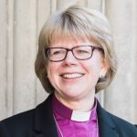 Woman bishop wearing purple shirt and collar