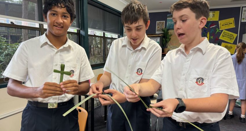 Teenage boy school students in uniform making palm crosses