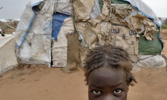 A girl in front of a makeshift tent in Darfur