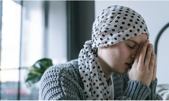 Woman with scarf around her head praying