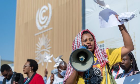 Woman at a protest with a megaphone at a United Nations climate change conference