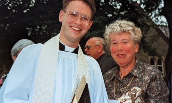 A young newly ordained priest and mother