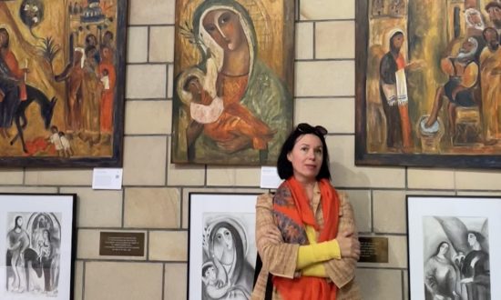 Award-winning Brisbane artist Olga Bakhtina standing in front of several art works at St John’s Anglican Cathedral