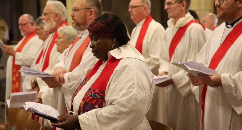 African woman priest in robes in a Cathedral