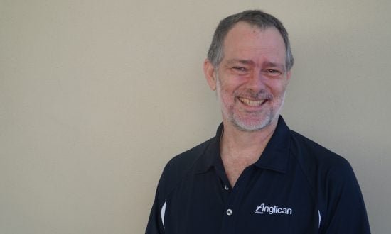 Man wearing navy polo shirt smiling