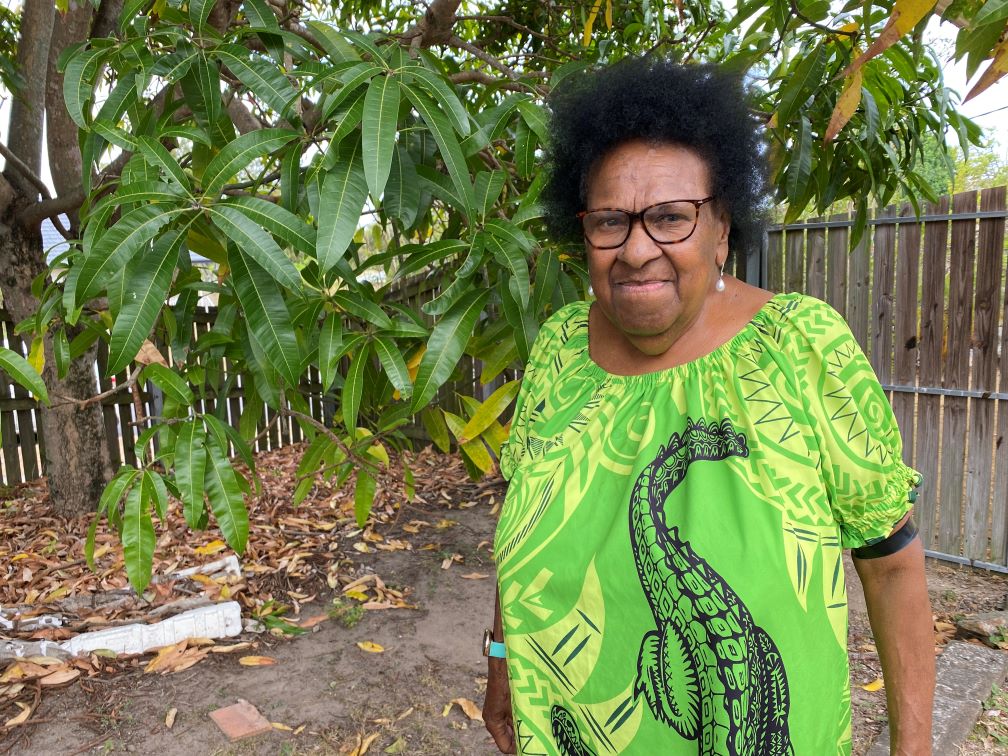 Aunty Dr Rose Elu wearing a green crocodile dress