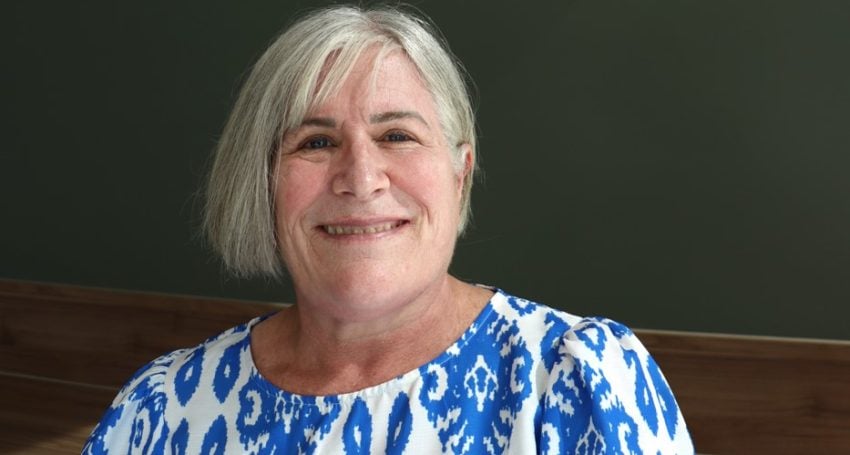 Woman wearing blue and white shirt