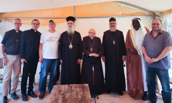 Eight religious leaders standing in robes or casual clothes