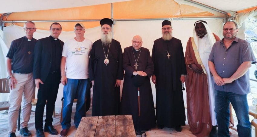 Eight religious leaders standing in robes or casual clothes