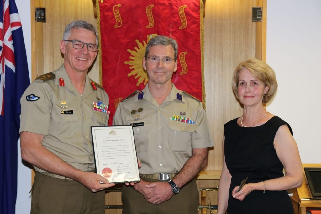 Two Army officers and a woman during a presentation 