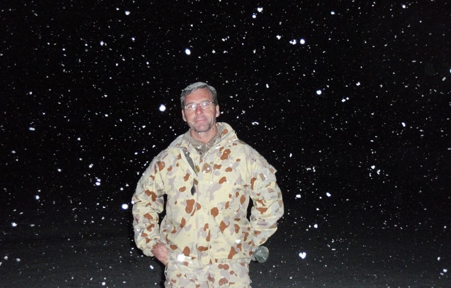 Man wearing Army camouflage in the snow