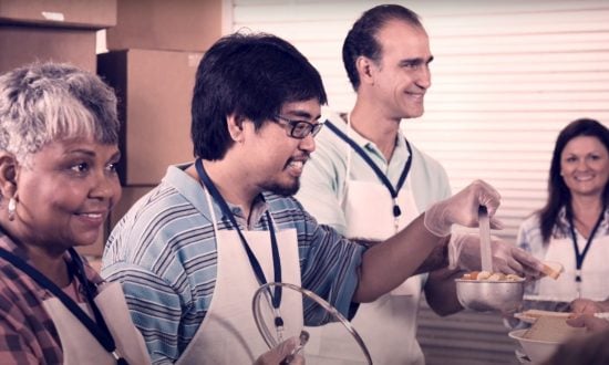 Diverse people in a church serving food while smiling