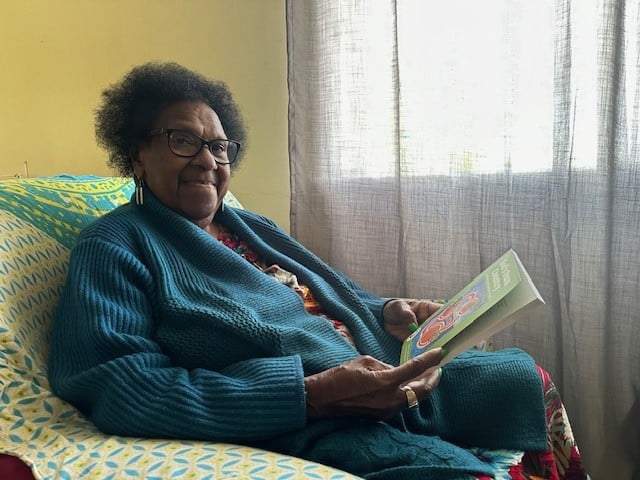 Saibai elder reading a book in her home 