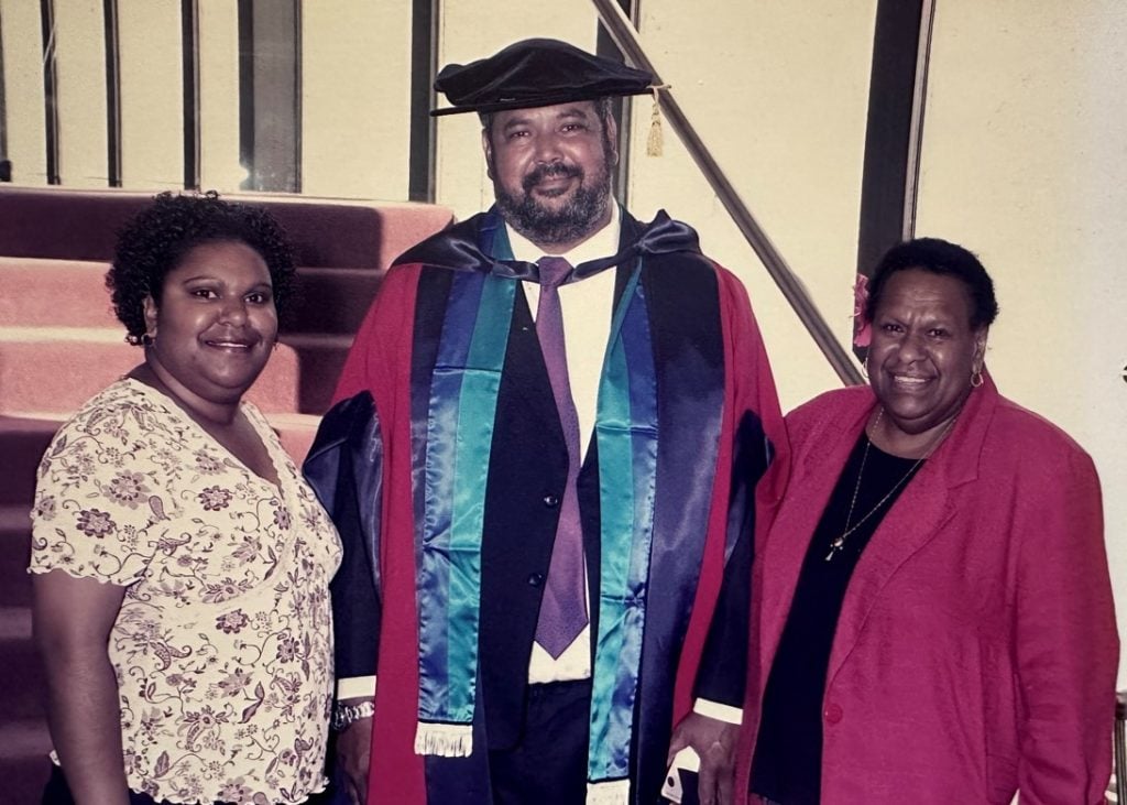 Three Torres Strait Islander people at a PhD graduation 