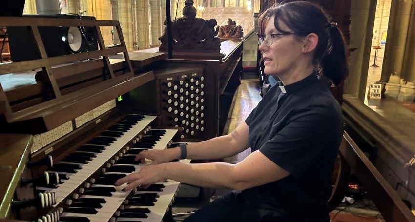 Woman priest playing the organ