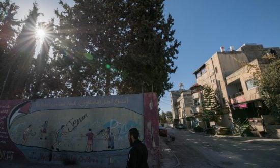 Man walking by wall in Bethlehem