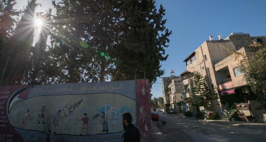 Man walking by wall in Bethlehem