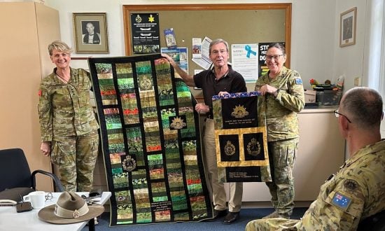 Three army chaplains and a quilt presentation