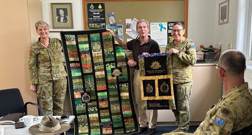 Three army chaplains and a quilt presentation