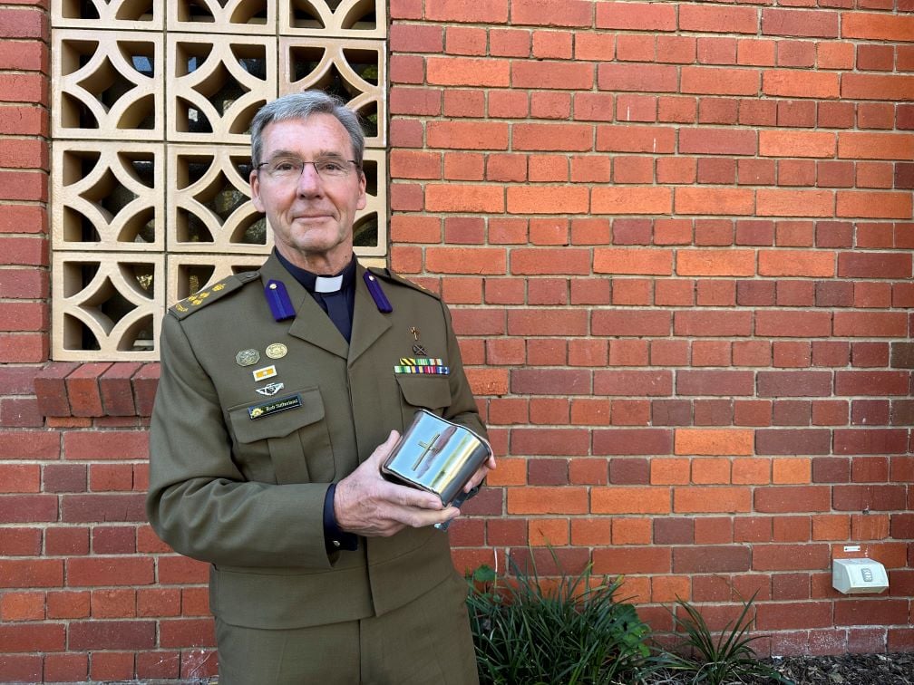 Army chaplain in dress uniform with a chalice 