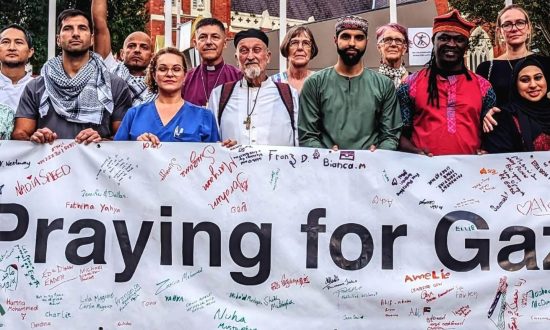 Inter-faith leaders holding a banner in the Brisbane CBD